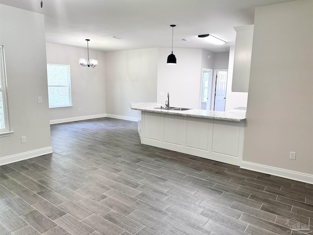 6283 Andys Ln, Milton, FL 32570 - kitchen with a sink, dark wood finished floors, baseboards, and light stone counters