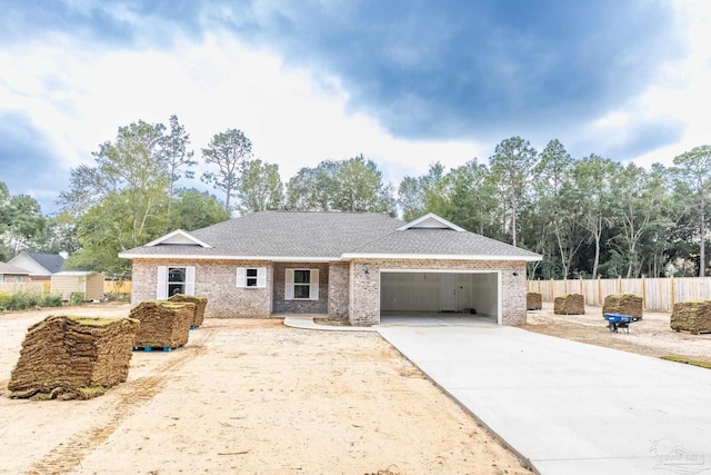 ranch-style home featuring roof with shingles, brick siding, fence, a garage, and driveway