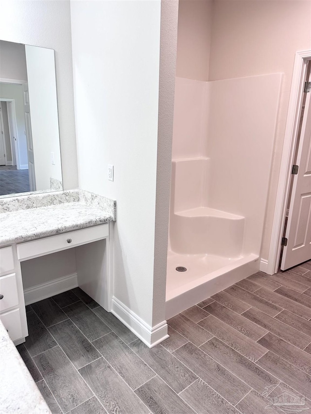 6283 Andys Ln, Milton, FL 32570 - full bath featuring wood tiled floors, vanity, baseboards, and a shower