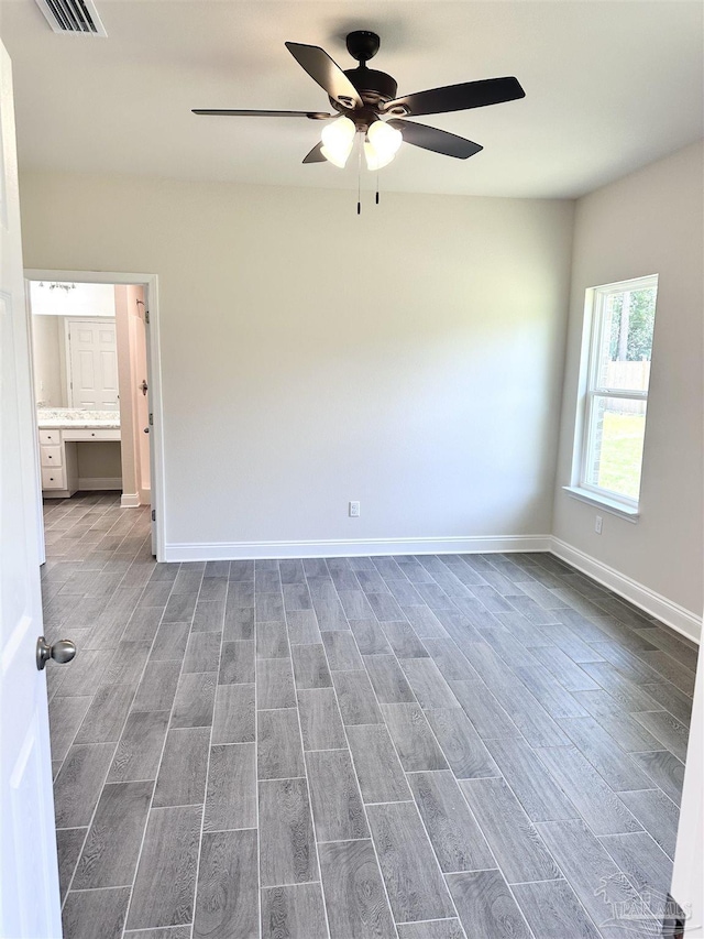 6283 Andys Ln, Milton, FL 32570 - unfurnished room with wood finished floors, ceiling fan, and baseboards