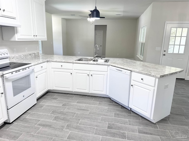 6283 Andys Ln, Milton, FL 32570 - kitchen with white appliances, a sink, under cabinet range hood, a ceiling fan, and a peninsula