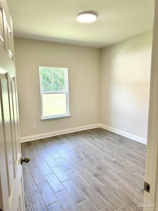 6283 Andys Ln, Milton, FL 32570 - spare room featuring dark wood-style floors and baseboards