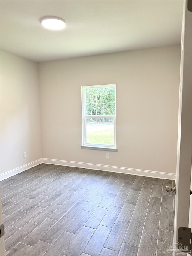 6283 Andys Ln, Milton, FL 32570 - empty room featuring baseboards and dark wood-style flooring