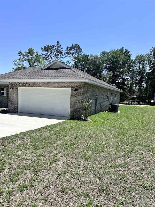 6283 Andys Ln, Milton, FL 32570 - view of side of property with an attached garage, brick siding, concrete driveway, a yard, and central AC