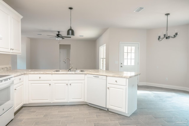 kitchen featuring a peninsula, white appliances, a sink, white cabinets, and light countertops