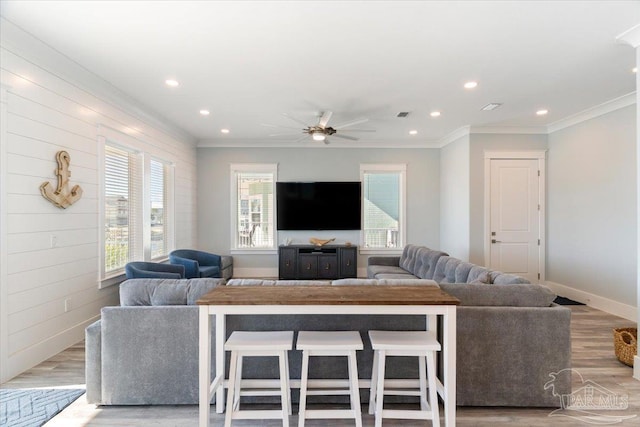 living room featuring ceiling fan, light hardwood / wood-style flooring, and ornamental molding