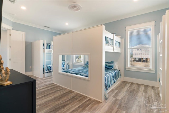 bedroom with hardwood / wood-style flooring and crown molding