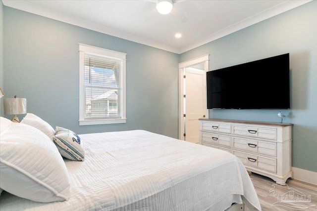 bedroom with ceiling fan, crown molding, and light hardwood / wood-style floors