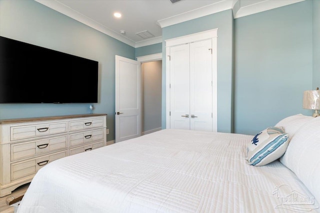 bedroom with crown molding and a closet