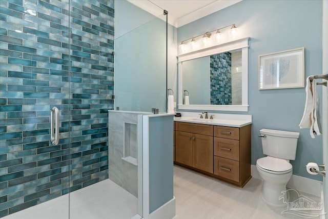 bathroom featuring vanity, toilet, and a shower with shower door