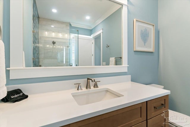 bathroom featuring vanity, ornamental molding, and walk in shower