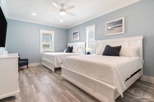 bedroom featuring ceiling fan, light hardwood / wood-style floors, and ornamental molding