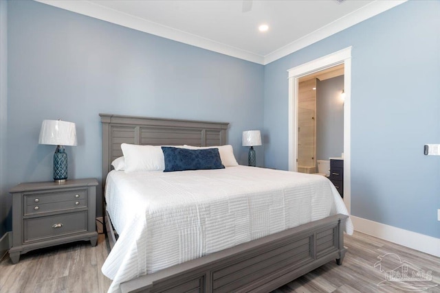 bedroom featuring ensuite bathroom, light wood-type flooring, and crown molding