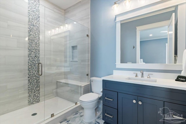 bathroom featuring vanity, toilet, and a shower with door