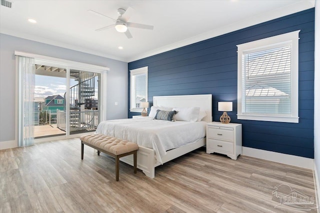 bedroom featuring access to outside, wooden walls, ceiling fan, ornamental molding, and light hardwood / wood-style floors