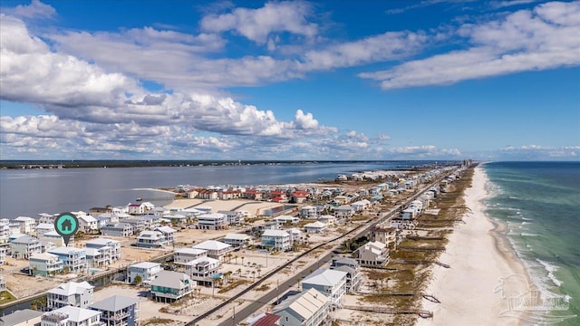 drone / aerial view with a water view and a view of the beach