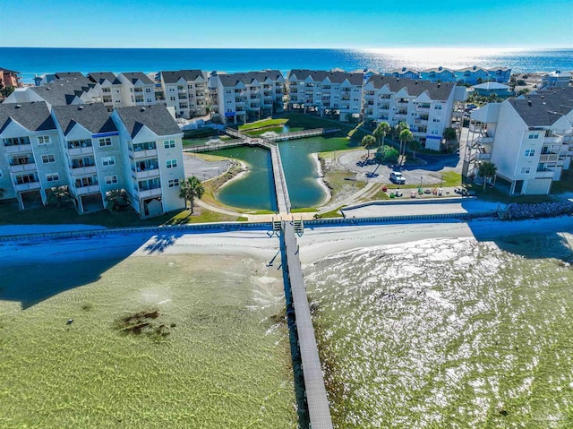 bird's eye view featuring a water view and a view of the beach