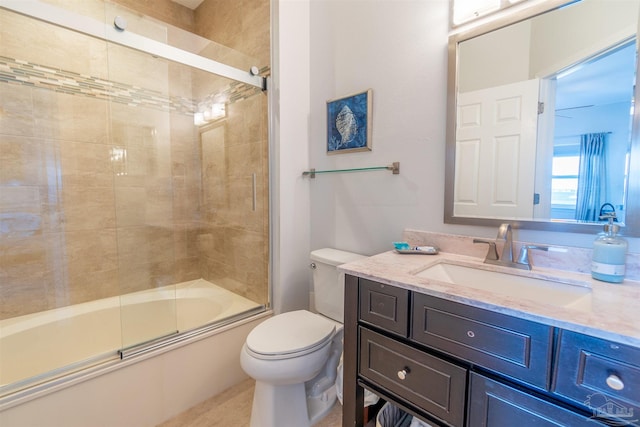 full bathroom featuring toilet, combined bath / shower with glass door, and vanity