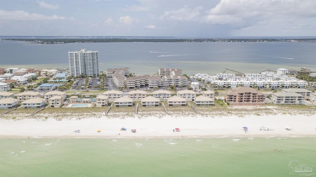 bird's eye view with a water view and a beach view