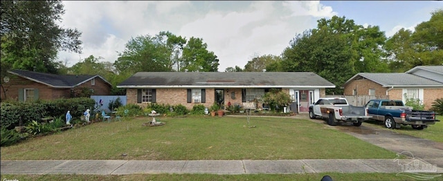 ranch-style home with a front lawn and brick siding