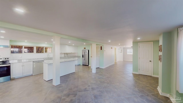 kitchen with white cabinets and appliances with stainless steel finishes