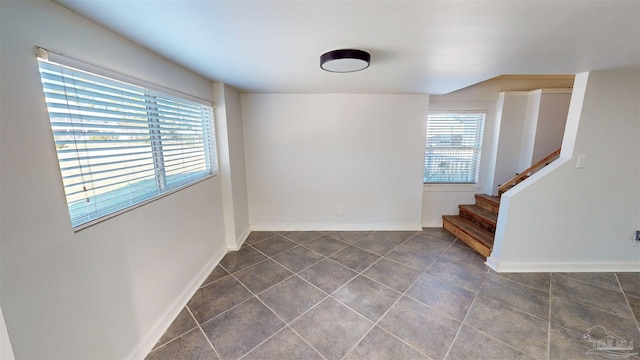 empty room featuring dark tile patterned flooring