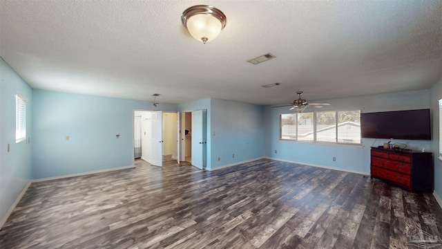 unfurnished living room featuring ceiling fan, a textured ceiling, and dark hardwood / wood-style floors