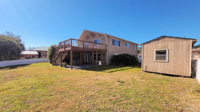 rear view of house with a storage shed, a wooden deck, and a yard