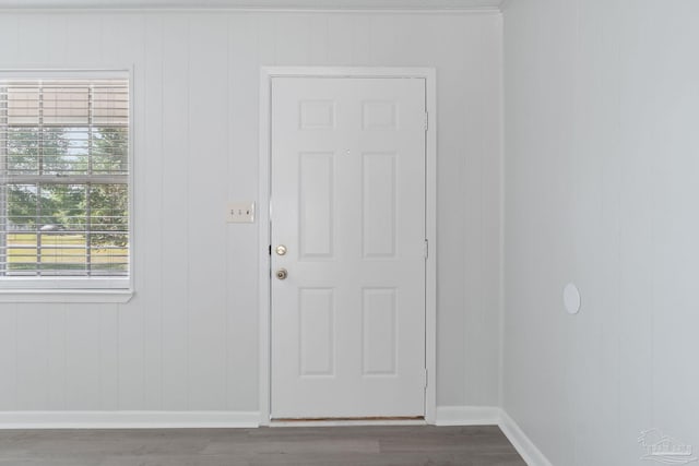doorway to outside with wood finished floors and baseboards