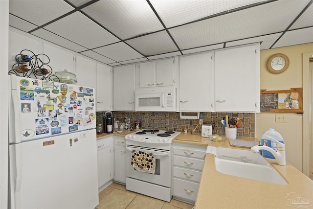 kitchen featuring light countertops, white cabinetry, a sink, and white appliances