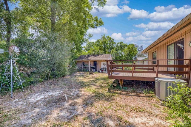 view of yard featuring a wooden deck and cooling unit