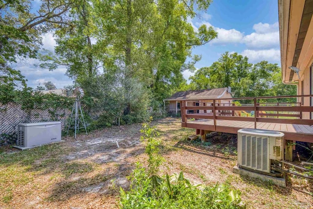 view of yard with a wooden deck and central AC