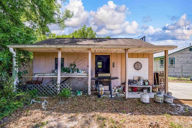 bungalow with fence, roof with shingles, and board and batten siding