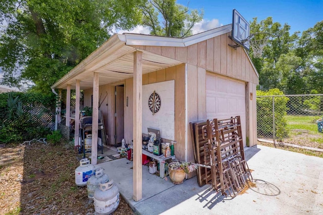 view of outbuilding with fence and an outbuilding
