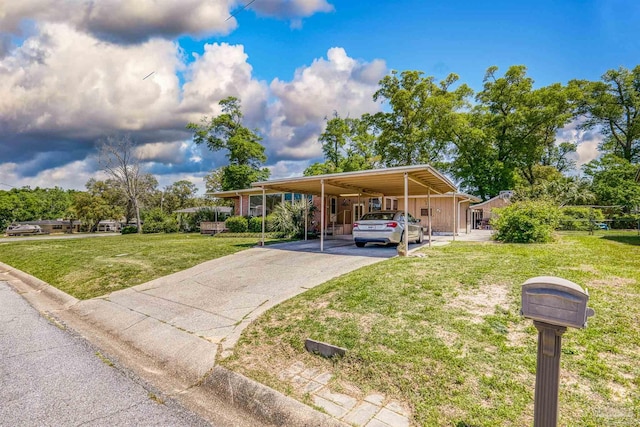 view of front of home with a front lawn, aphalt driveway, and an attached carport