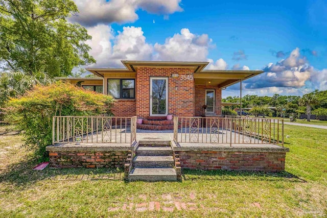 exterior space featuring brick siding and a lawn