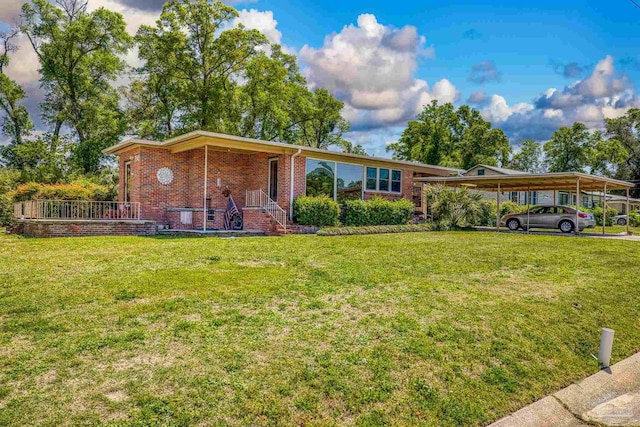 ranch-style home with a front lawn, brick siding, and a carport