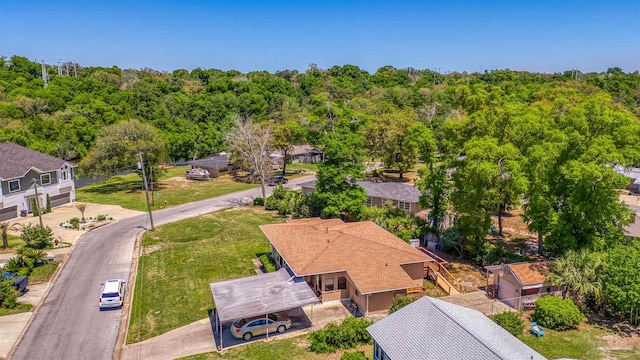 drone / aerial view with a residential view and a wooded view