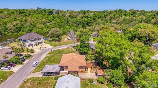 bird's eye view with a wooded view