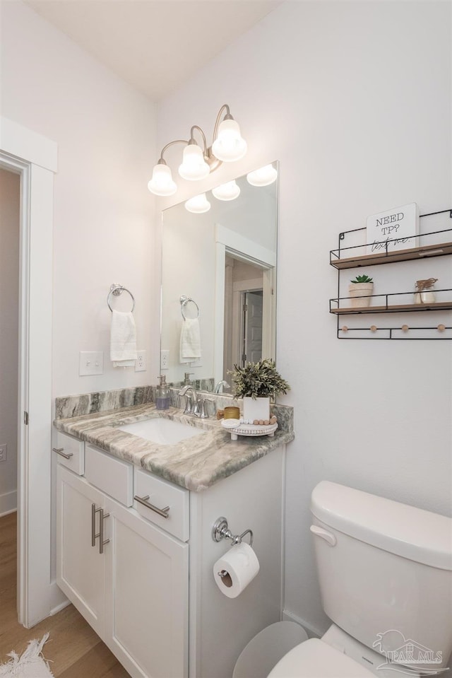 1928 Appleton Dr, Cantonment, FL 32533 - half bathroom with toilet, vanity, and wood finished floors