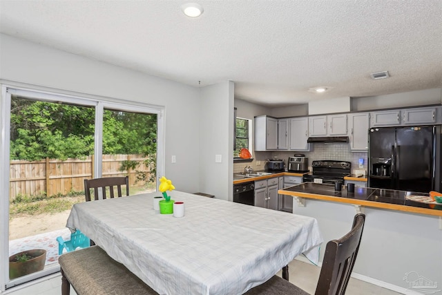dining room featuring visible vents, a textured ceiling, and recessed lighting