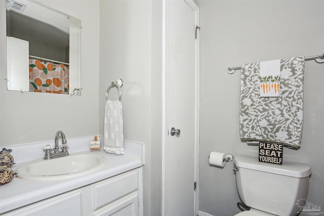 full bath with visible vents, vanity, and toilet