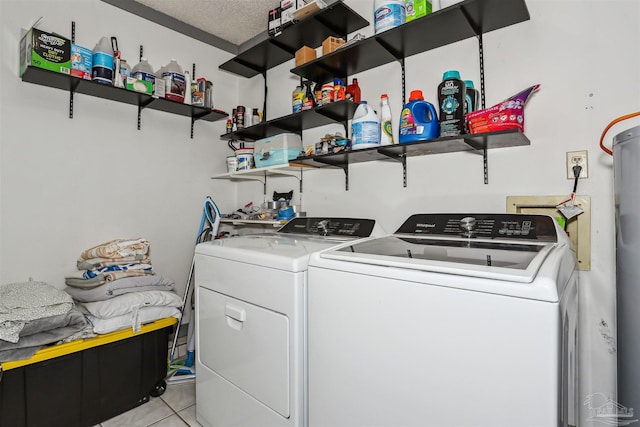 laundry room with independent washer and dryer, light tile patterned floors, and laundry area