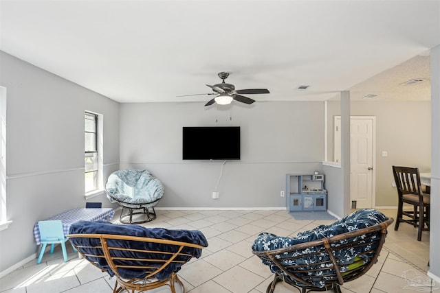 living room with a ceiling fan, visible vents, and tile patterned flooring