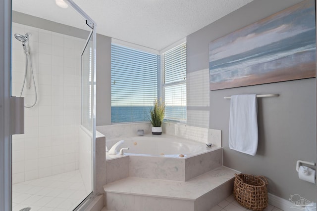 bathroom featuring tile patterned flooring, shower with separate bathtub, a textured ceiling, and a water view