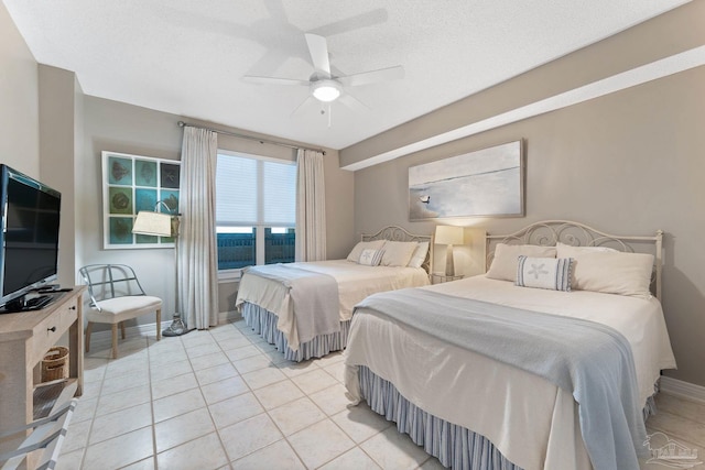 bedroom featuring light tile patterned floors, a textured ceiling, and ceiling fan