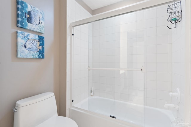 bathroom featuring tiled shower / bath and toilet