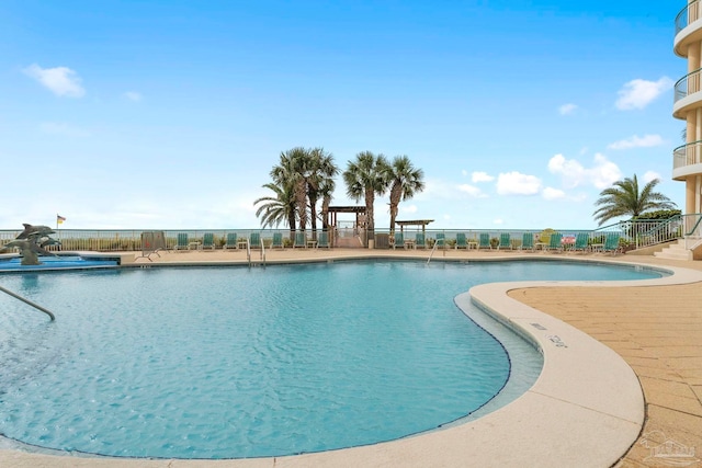 view of swimming pool featuring a patio area