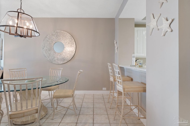 tiled dining space featuring a chandelier