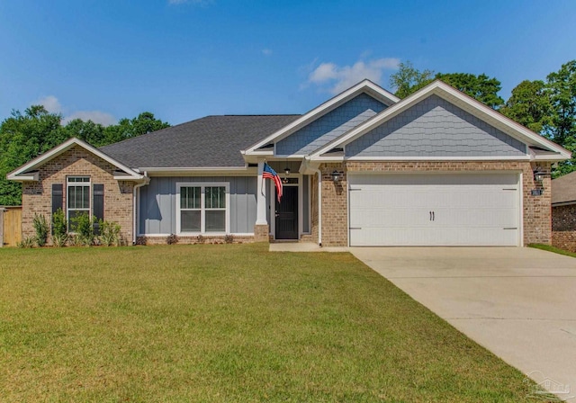 1825 Peace Ter, Cantonment, FL 32533 - view of front facade featuring concrete driveway, a front lawn, board and batten siding, a garage, and brick siding